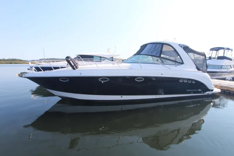 A 2008 Chaparral 350 Signature is docked in the water. It features a sleek, modern design.