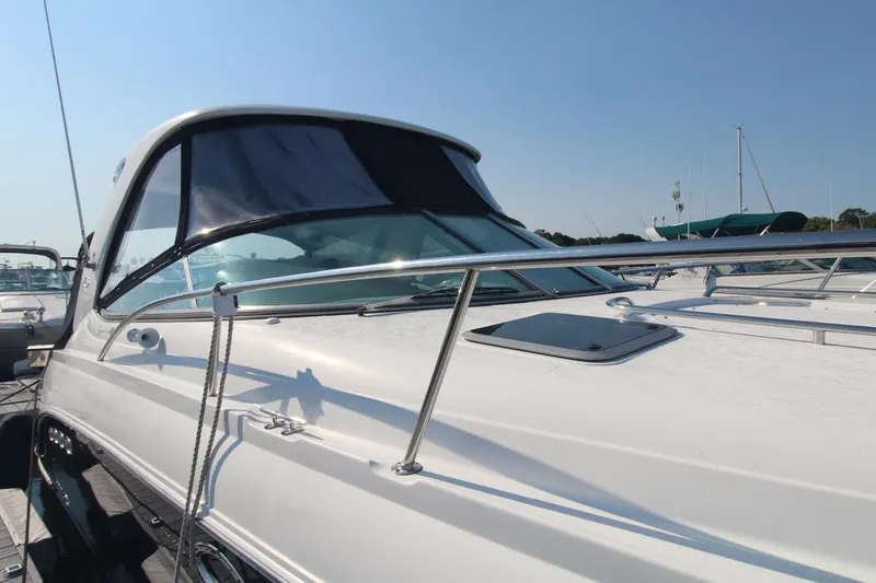 The 2008 Chaparral 350 Signature features a sleek design with stainless steel railings and tinted windows.