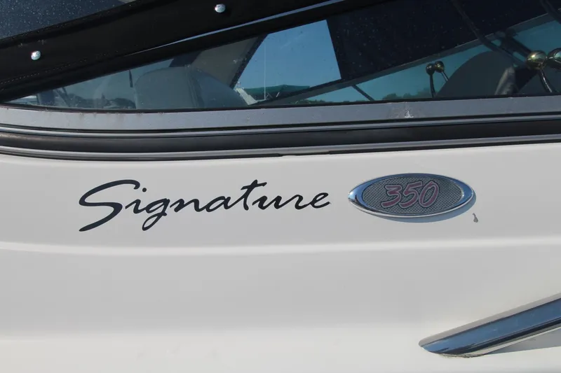 Close-up of the "Signature 350" lettering on a white boat.