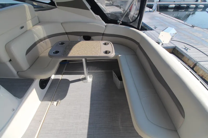 The image shows the seating area of a 2008 Chaparral 350 Signature boat with a table.