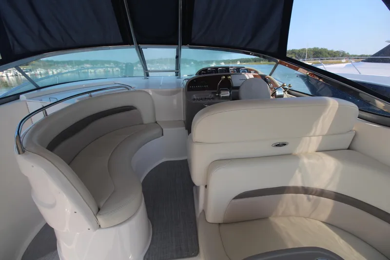 The image shows the cockpit of a 2008 Chaparral 350 Signature with beige seating and a helm station.