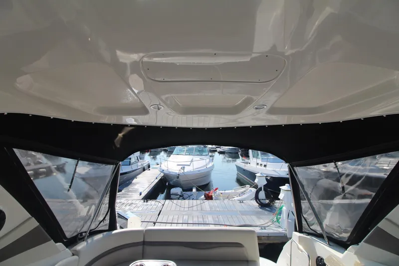 View from inside a Chaparral 350 Signature boat looking out at a marina with several boats.