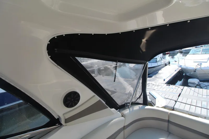 Interior view of a 2008 Chaparral 350 Signature with cushioned seating and windows.