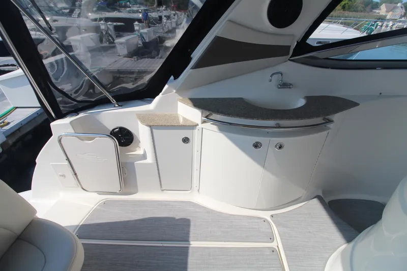 The image shows the cockpit of a 2008 Chaparral 350 Signature with a small sink and storage.