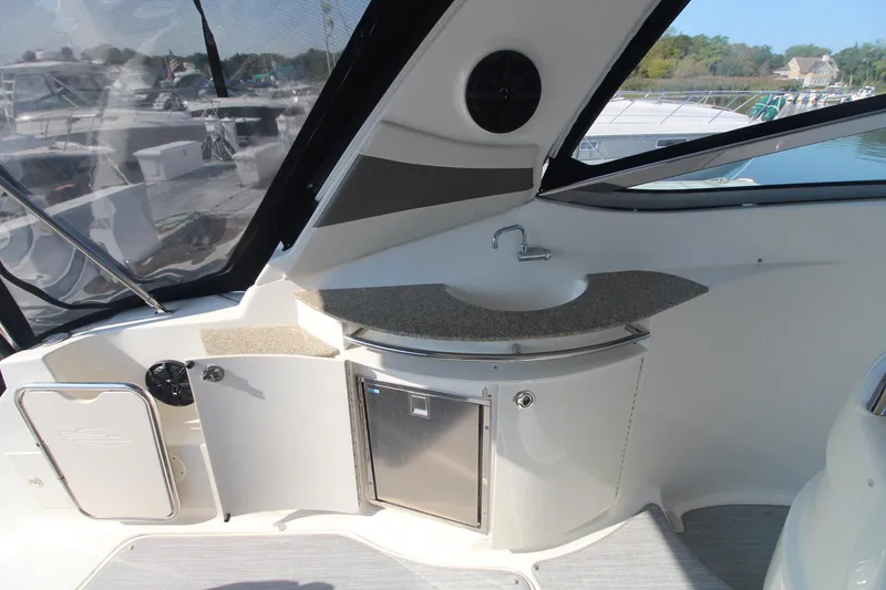 The 2008 Chaparral 350 Signature features a compact outdoor kitchenette with a sink and storage.