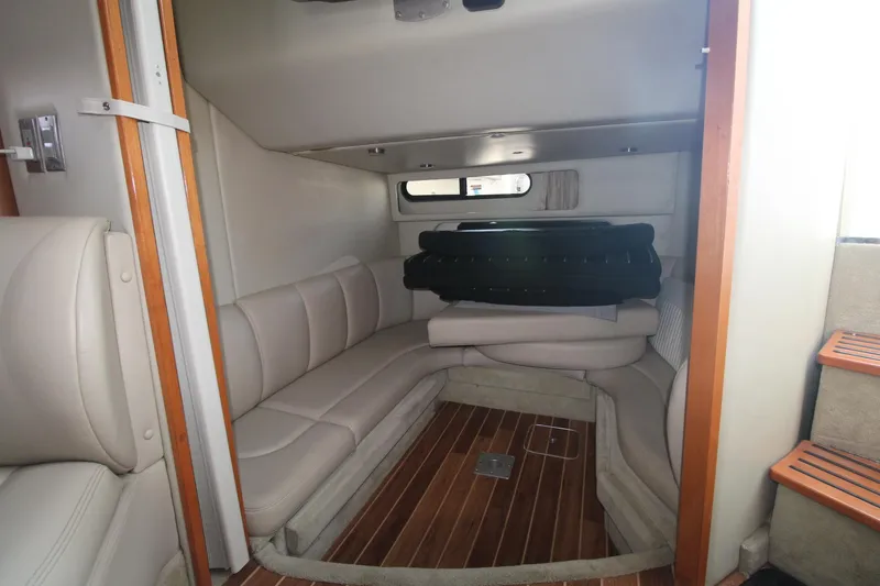 Interior of the 2008 Chaparral 350 Signature with beige sofa and wooden floor.