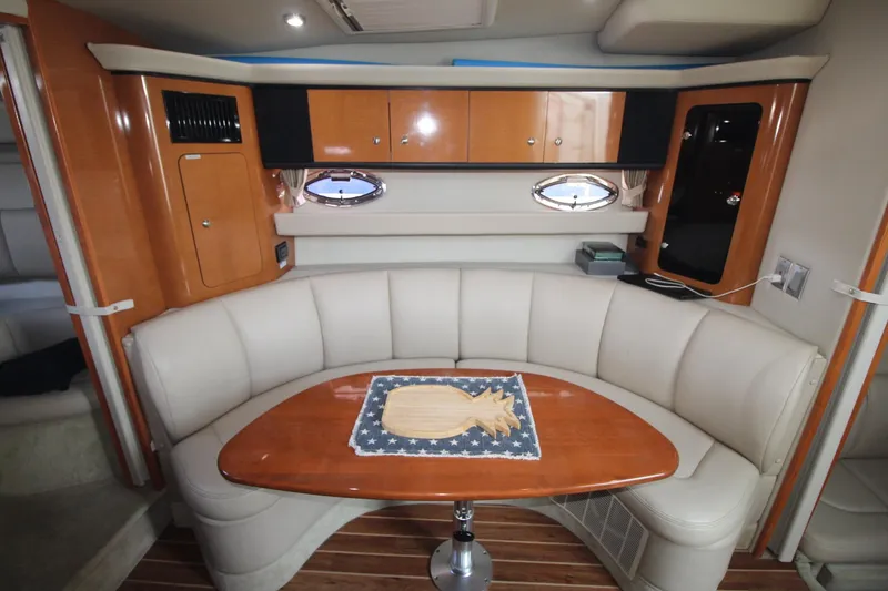 Interior of the 2008 Chaparral 350 Signature with elegant seating area and wooden table.