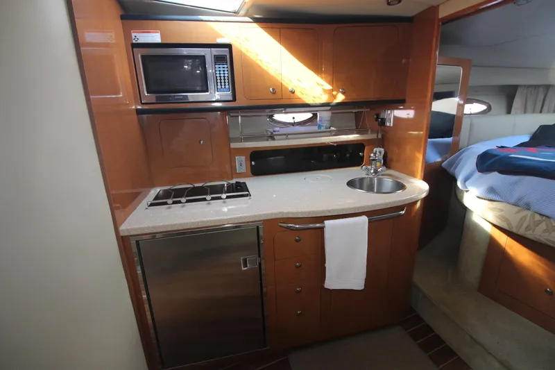 Galley of the 2008 Chaparral 350 Signature with microwave, sink, and refrigerator.