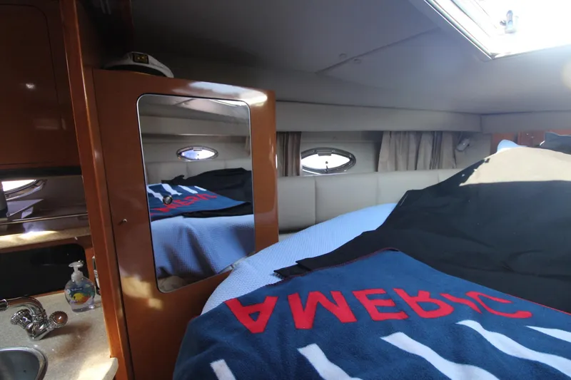 Interior of a 2008 Chaparral 350 Signature with bed and mirror.