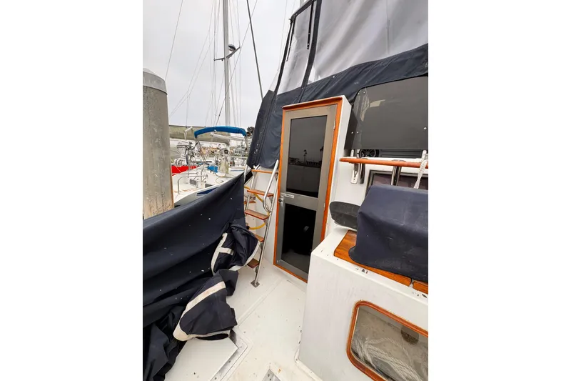 Sailboat deck view with covered equipment, Symbol 51, 1985 model.