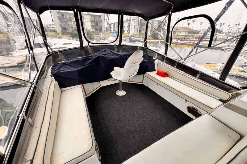 Interior of a 1985 Symbol 51 boat with seating and marina view.