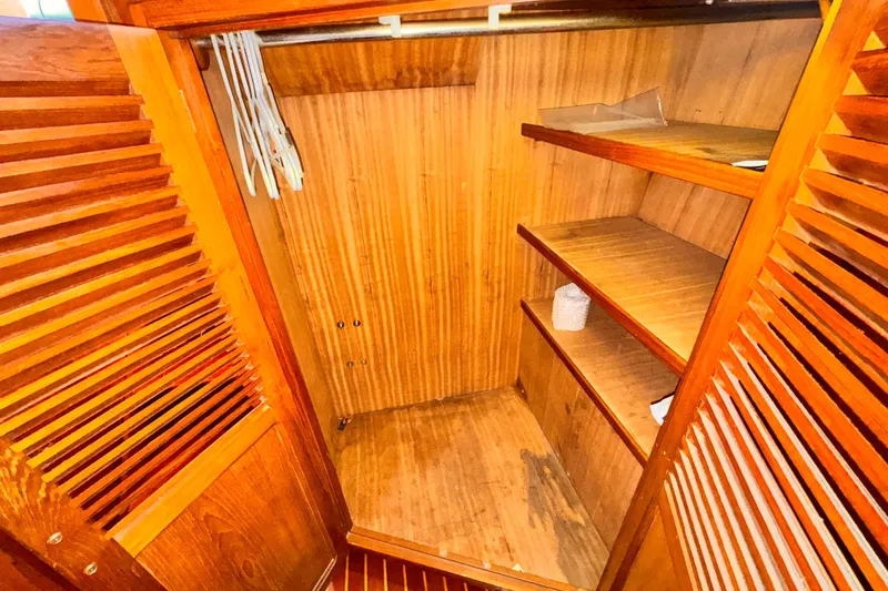 Wooden closet interior with shelves and hangers, Symbol 51 model, 1985.