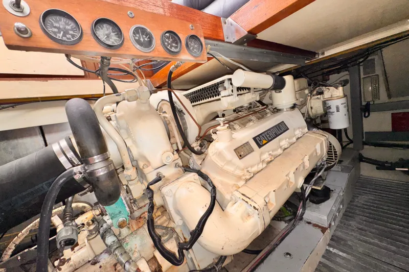 Engine room of a 1985 Symbol 51 yacht with Caterpillar engine and gauges.