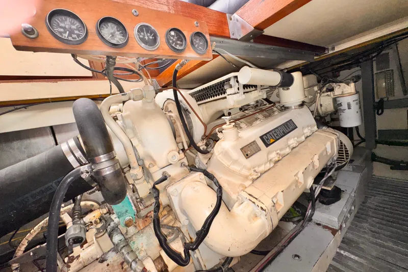 Engine room of a 1985 Symbol 51 yacht with Caterpillar engine and gauges.