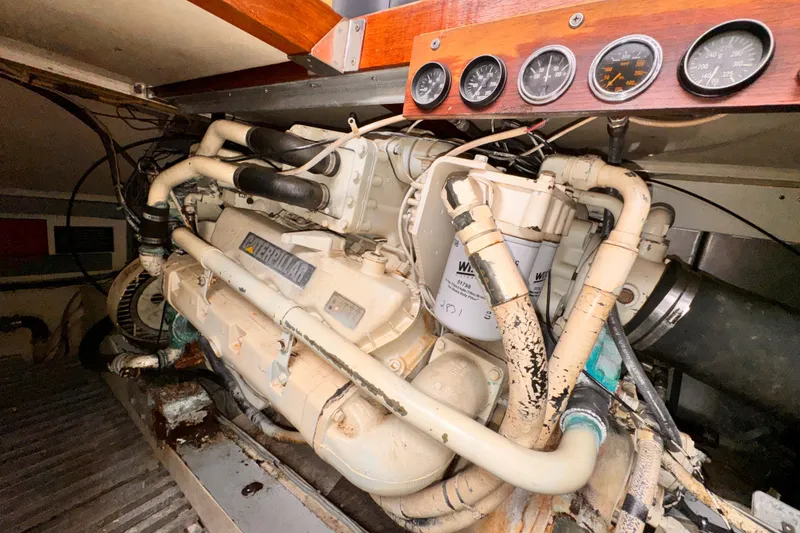 Engine room of a 1985 Symbol 51 yacht with Caterpillar engine and gauges.