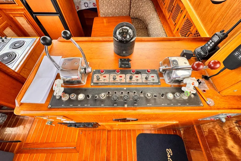 Control panel of a 1985 Symbol 51 yacht with navigation instruments and throttle levers.