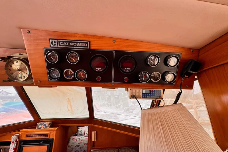 Control panel of a 1985 Symbol 51 boat with gauges and "Cat Power" label.