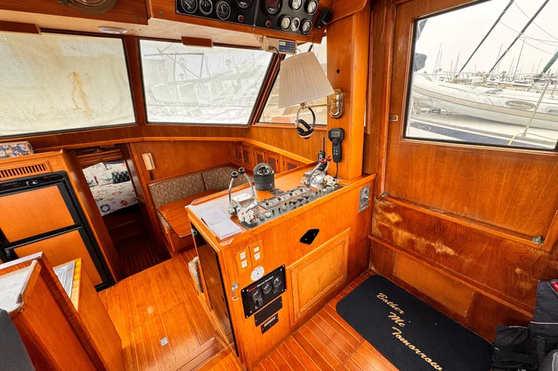 1985 Symbol 51 yacht interior with wooden paneling and navigation controls.
