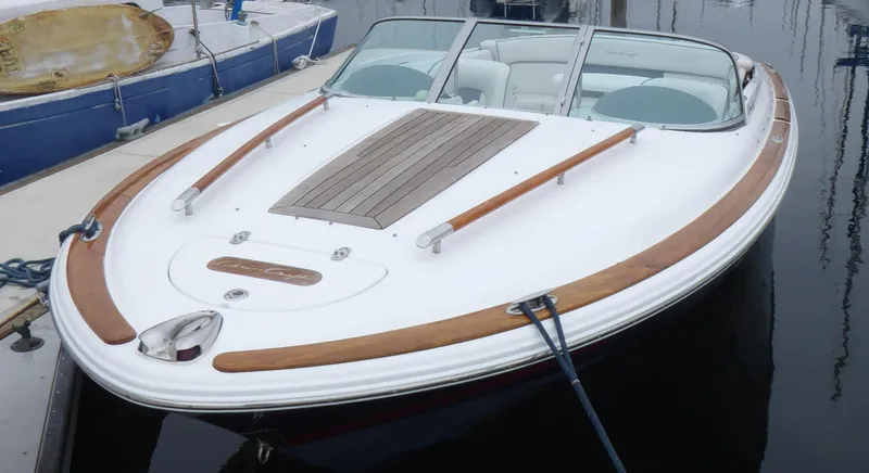 2004 Chris-Craft Corsair 25 boat docked in harbor.