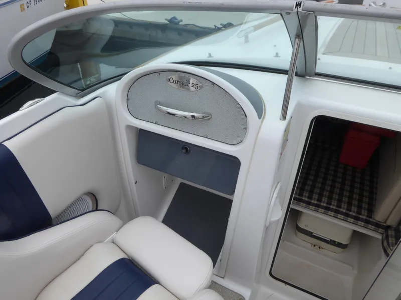 Interior of a 2004 Chris-Craft Corsair 25 boat, white and blue upholstery.