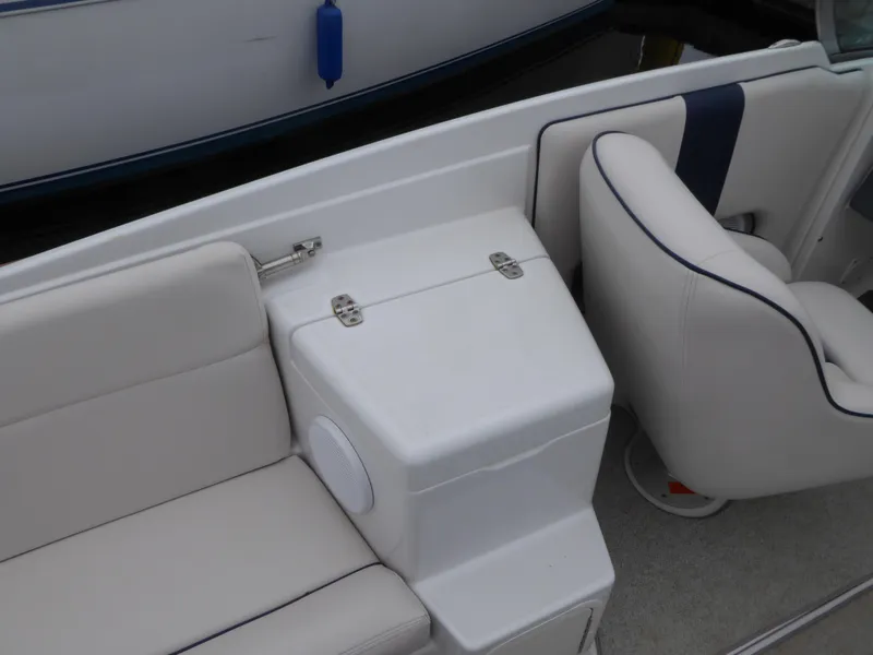 Interior of a 2004 Chris-Craft Corsair 25 boat with white seating.