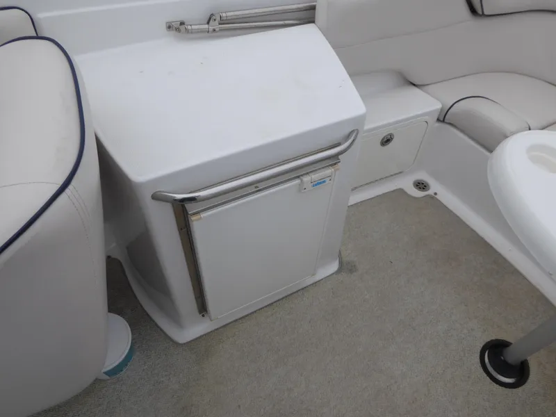 Interior of a 2004 Chris-Craft Corsair 25 boat with refrigerator.