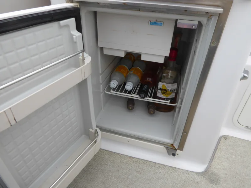 Open fridge on Chris-Craft Corsair 25 boat, stocked with beverages.
