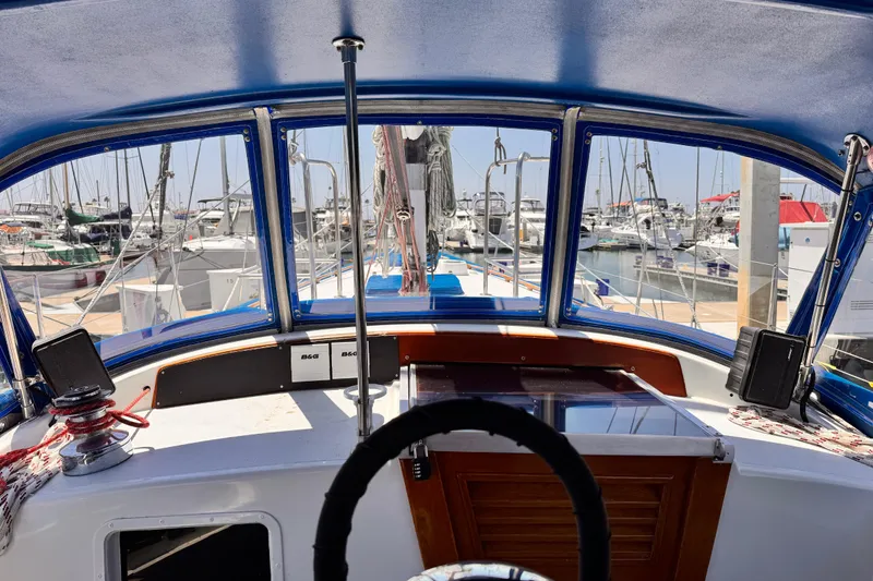 Cockpit view of 1982 Kelly Peterson 46 sailboat docked at marina.