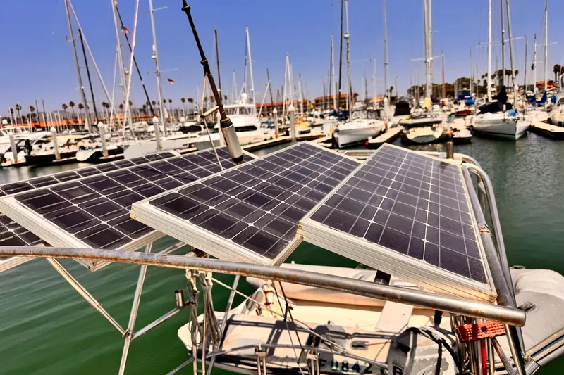 Solar panels on a 1982 Kelly Peterson 46 sailboat in a marina.