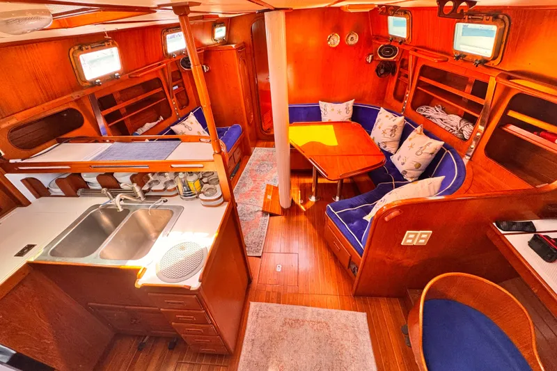 Interior of 1982 Kelly Peterson 46 yacht with wooden finish and cozy seating area.