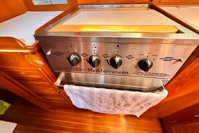 Stainless steel Mediterranean stove in 1982 Kelly Peterson 46 yacht kitchen.