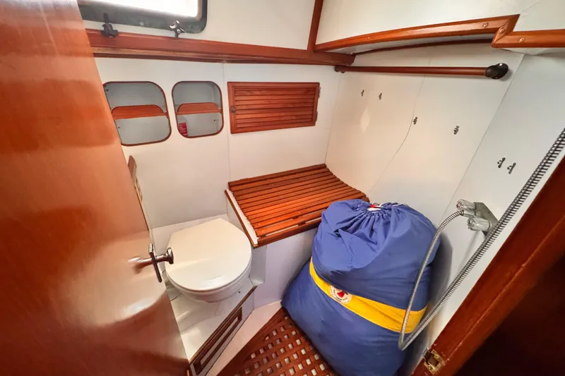 1982 Kelly Peterson 46 yacht bathroom with wooden accents and compact design.