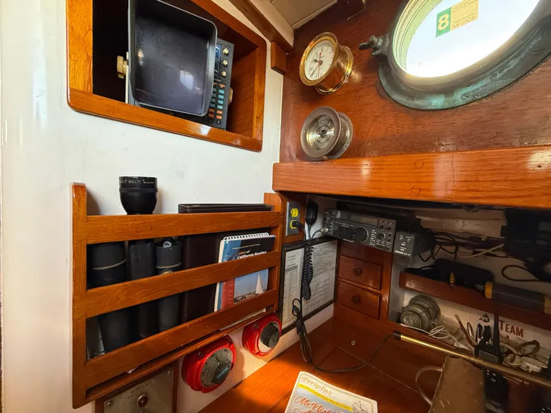 Interior of 1932 Historic Fellows & Stewart Yawl with vintage navigation equipment and wooden accents.