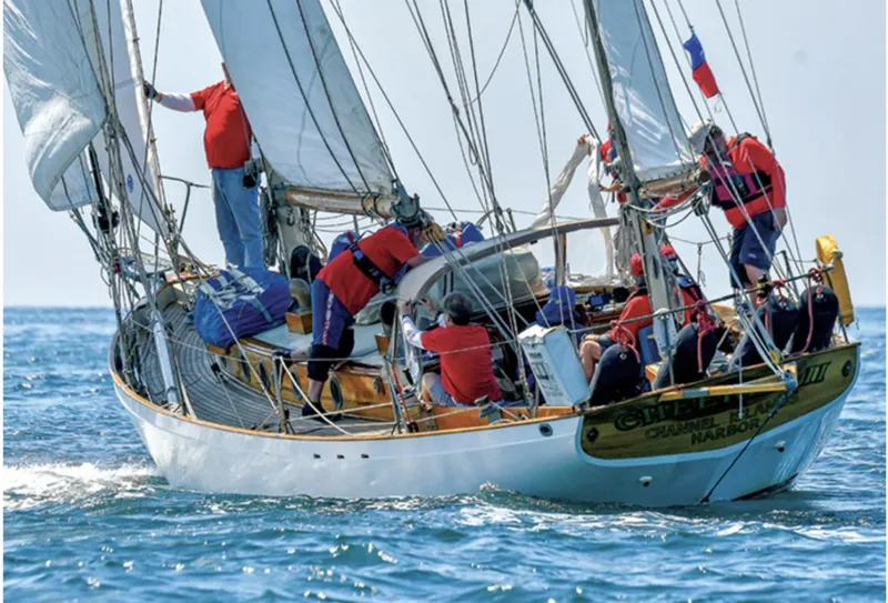 Historic 1932 Fellows & Stewart Yawl sailing with crew on open sea.