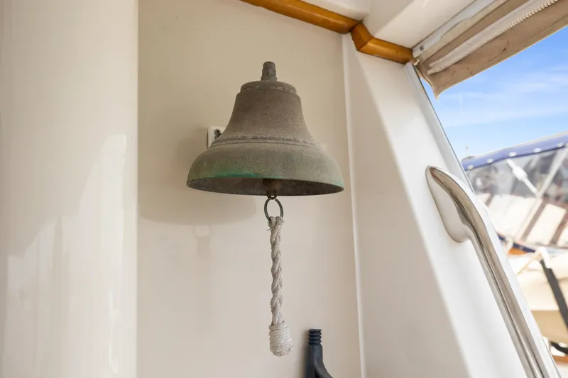 Bell on 1996 Kadey-Krogen 48 Whaleback yacht, with rope pull, nautical setting.