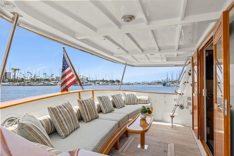 Luxurious 1996 Kadey-Krogen 48 Whaleback yacht deck with seating and American flag.