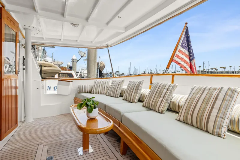 Kadey-Krogen 48 Whaleback 1996 yacht with cozy deck and American flag.