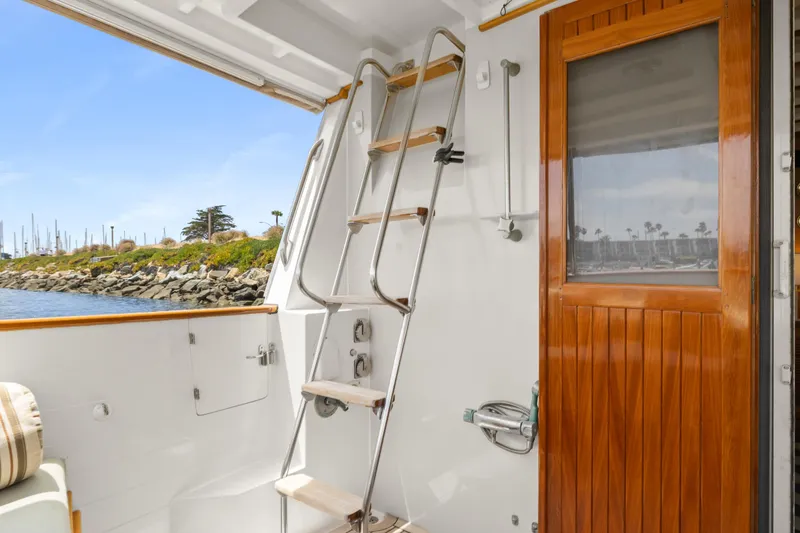 Kadey-Krogen 48 Whaleback yacht, 1996 model, featuring a wooden door and ladder on deck.