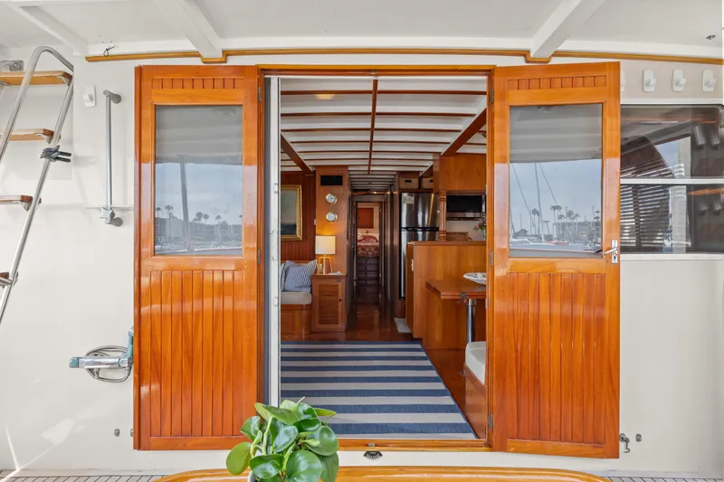 Interior view of 1996 Kadey-Krogen 48 Whaleback yacht with wooden doors and striped rug.