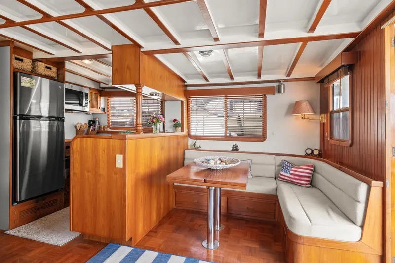 Interior of 1996 Kadey-Krogen 48 Whaleback yacht with cozy dining area and modern kitchen.