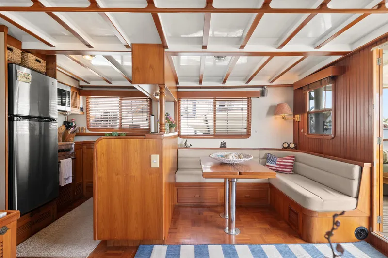 Interior of 1996 Kadey-Krogen 48 Whaleback yacht with cozy dining area and modern kitchen.