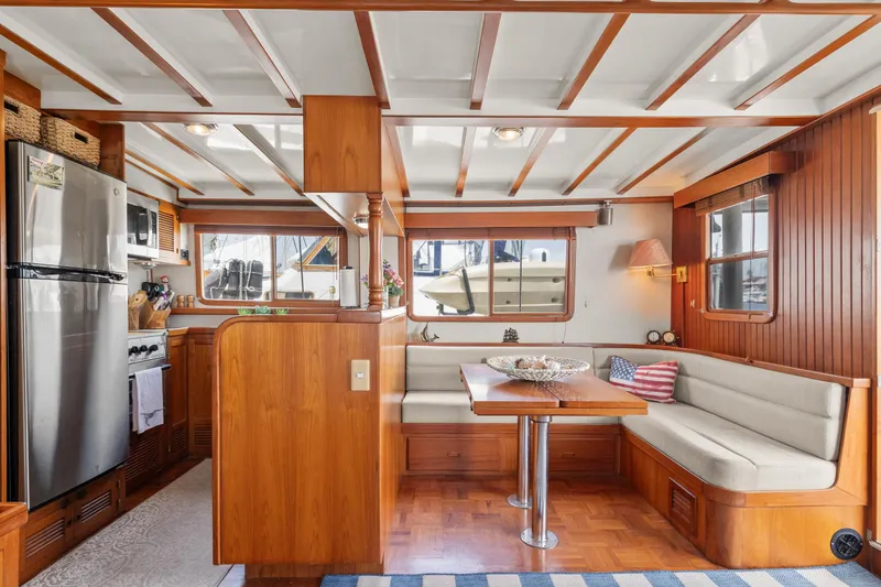 Interior of 1996 Kadey-Krogen 48 Whaleback yacht with wood finish and dining area.