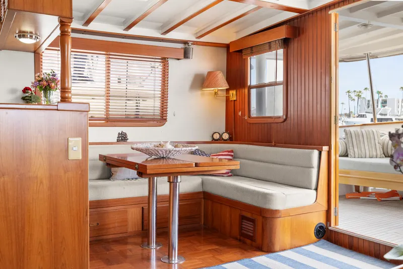 Interior of 1996 Kadey-Krogen 48 Whaleback yacht with cozy dining area and wooden accents.