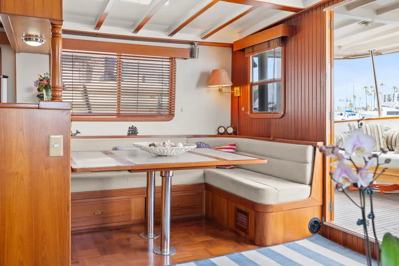 Interior of 1996 Kadey-Krogen 48 Whaleback yacht with cozy dining area and wooden accents.
