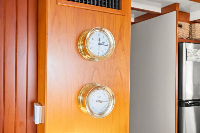 Brass clock and barometer on Kadey-Krogen 48 Whaleback, 1996, wooden interior.