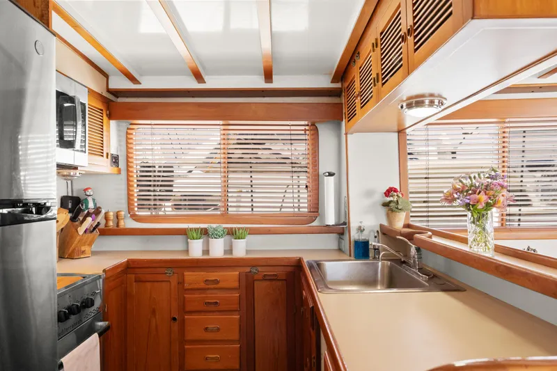 1996 Kadey-Krogen 48 Whaleback yacht kitchen with wooden cabinets and modern appliances.