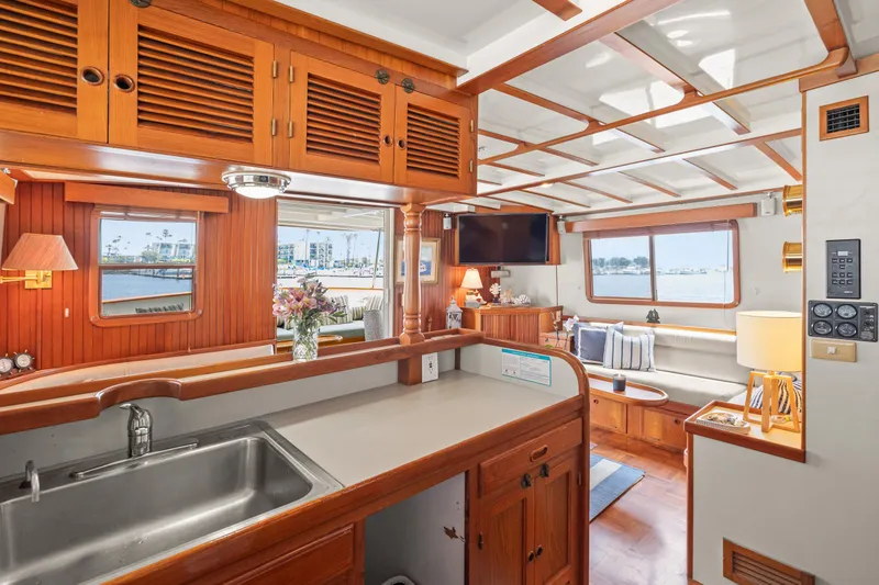 Interior of 1996 Kadey-Krogen 48 Whaleback yacht with wooden cabinetry and cozy seating area.