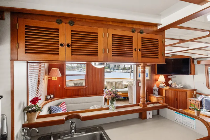 Interior of 1996 Kadey-Krogen 48 Whaleback yacht with wooden cabinetry and cozy seating area.
