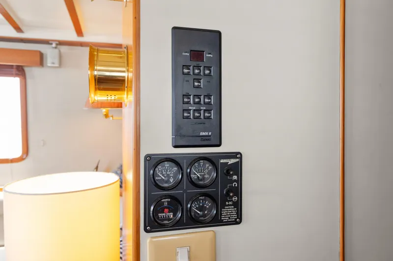 Control panel inside 1996 Kadey-Krogen 48 Whaleback yacht, featuring gauges and switches.