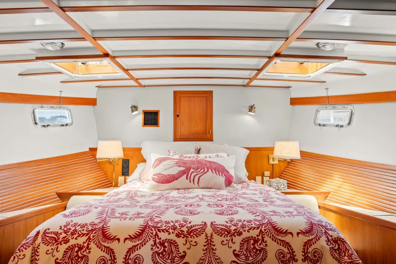 Luxurious 1996 Kadey-Krogen 48 Whaleback bedroom with elegant wood accents and nautical decor.